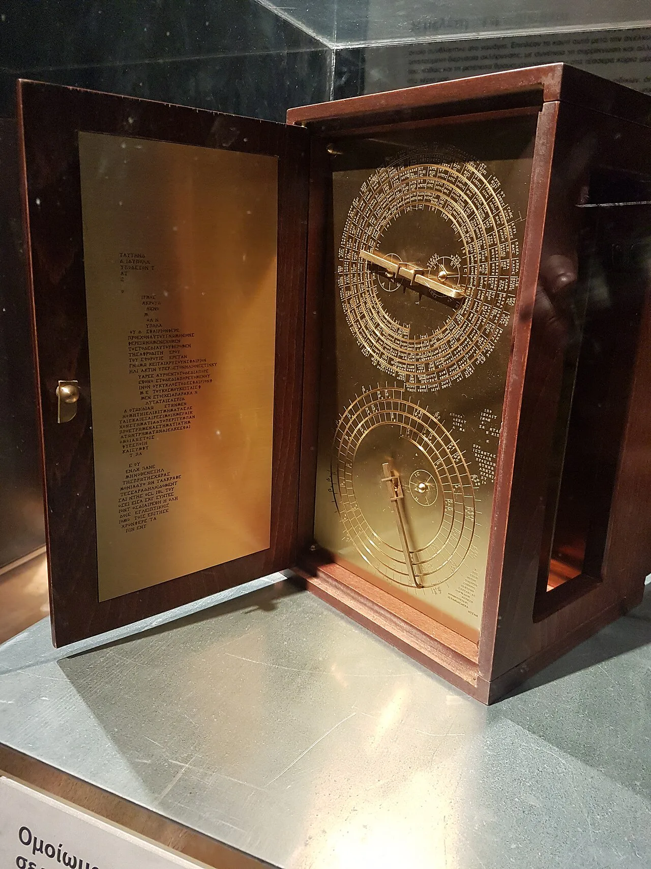 Front face of a modern reconstruction of the Antikythera mechanism with a circular astronomical dial