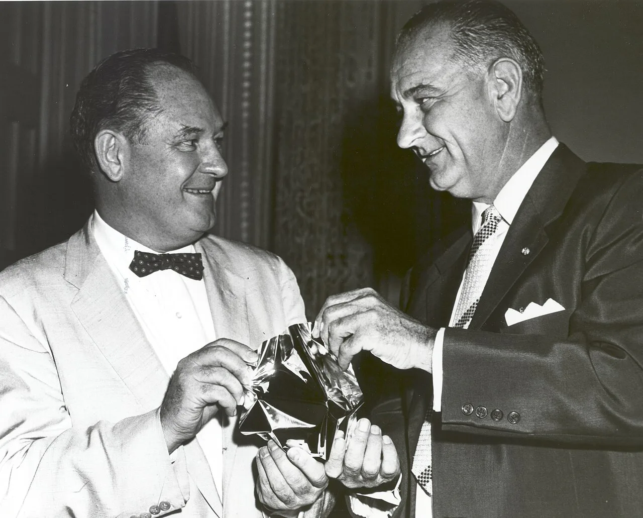 NASA administrator T. Keith Glennan showing Lyndon B. Johnson the aluminized Mylar film used for Echo I